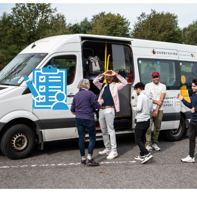 men in front of a minibus with one making a heart shape with their hands