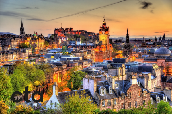 photo shows edinburgh sky line lit up at night 