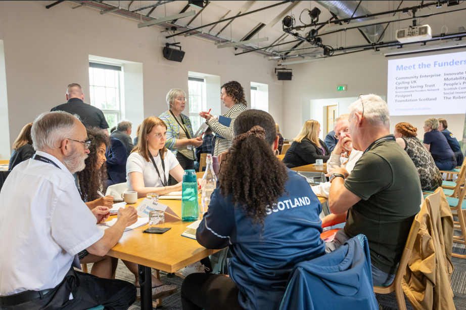 a group of people talking around a conference table