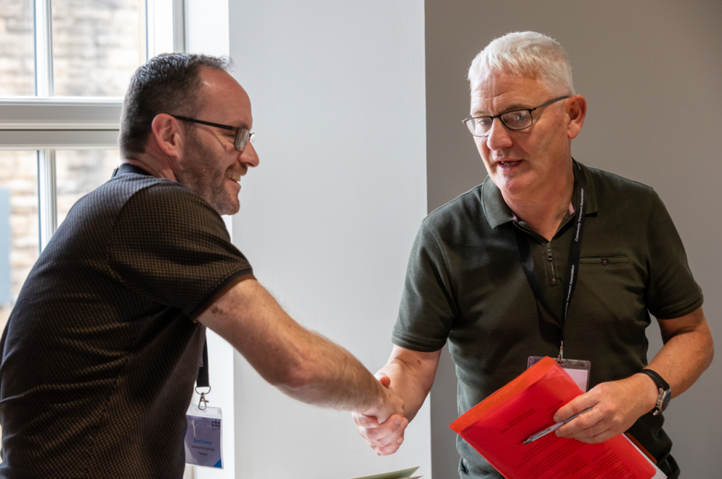 Duncan Thorp and John Reid shake hands