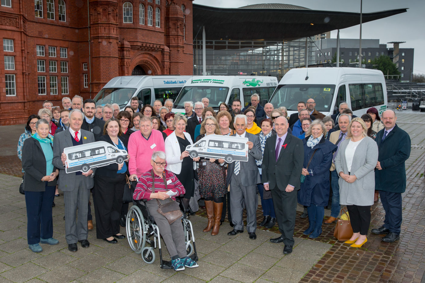 Group at the National Assembly for Wales in front of minibuses