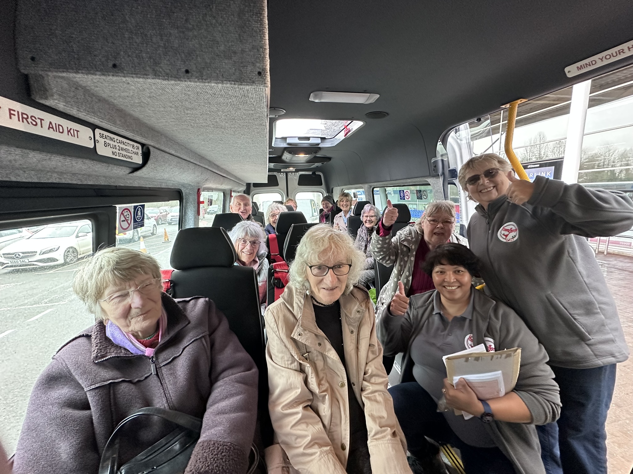 Various passengers sat in a community transport vehicle
