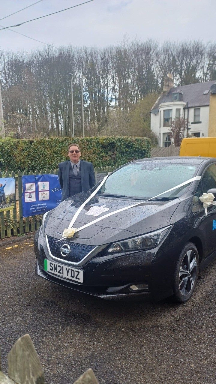 Image of a car with wedding ribbon on it