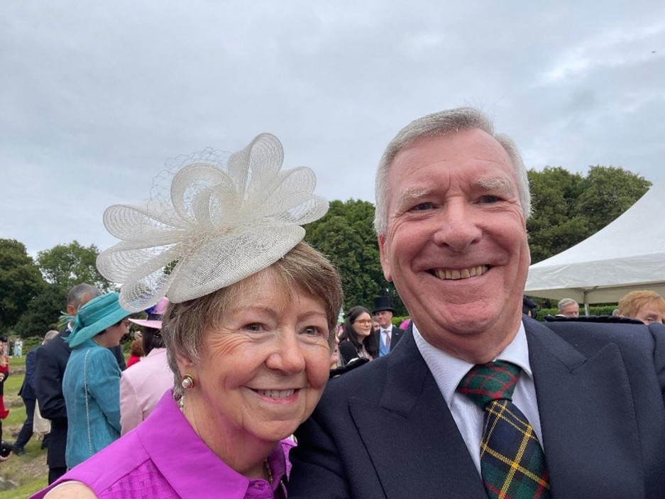An image of Colin Stratton pictured with his wife wearing formal clothes