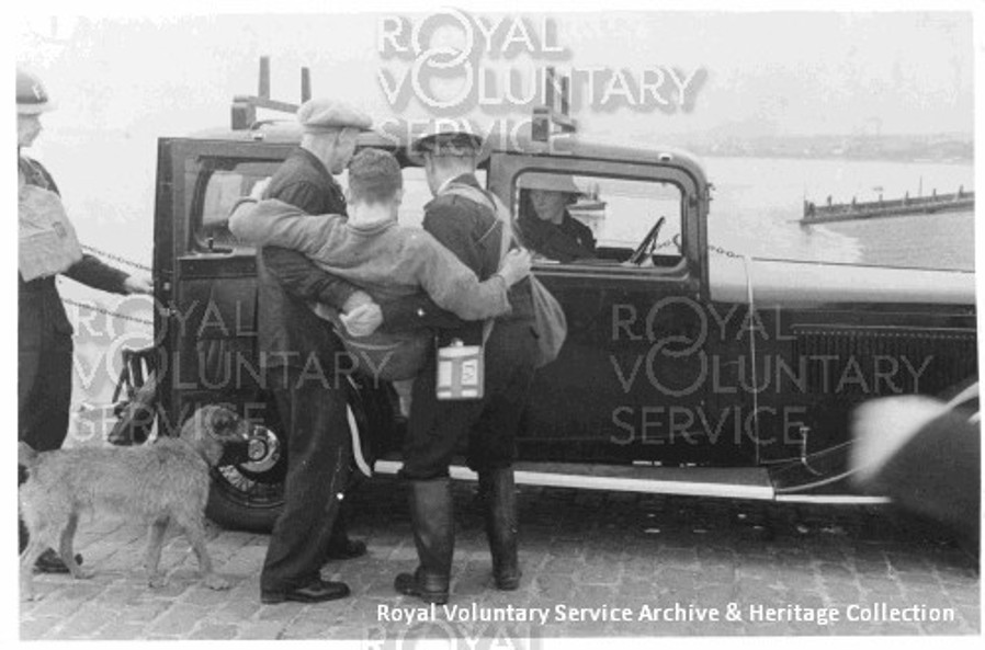 Image from RVS of an injured person being put into a voluntary ambulance vehicle during the war