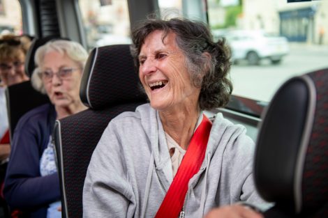 Woman-smiling-on-minibus