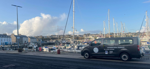 blue minibus on a quayside in Scotland