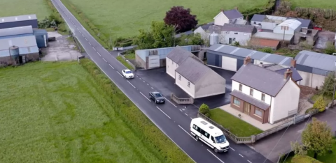 minibus driving through a northern ireland town