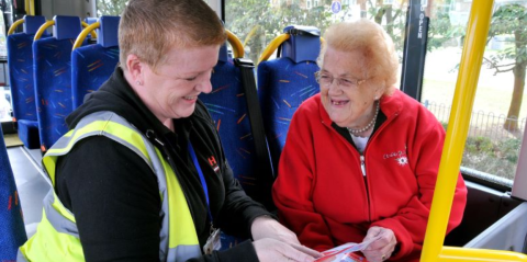 two women on a minibus smiling and laughing 