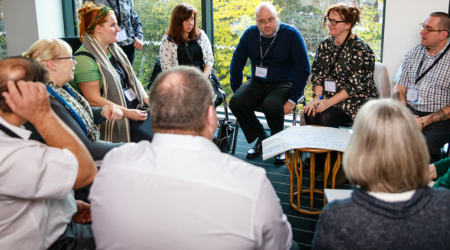  photo showing a group of seated people chatting