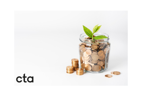 photo showing a glass jar of coins with a green sprouting leaf on the top