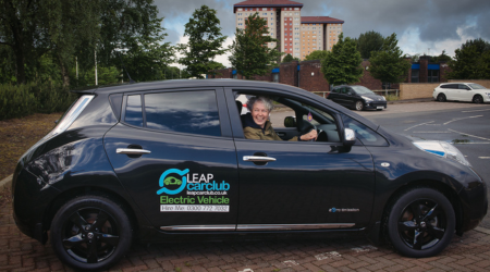 A woman sits in a car 