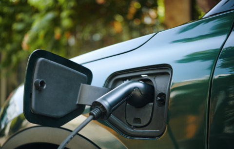 An image of an electric vehicle being plugged in to the charging port