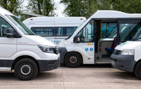 Images of multiple white minibuses