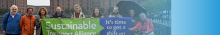 staff and volunteers holding a green and blue banner on the Liverpool water front 