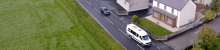 minibus driving through a northern ireland town