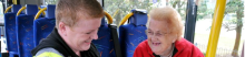 two women on a minibus smiling and laughing 